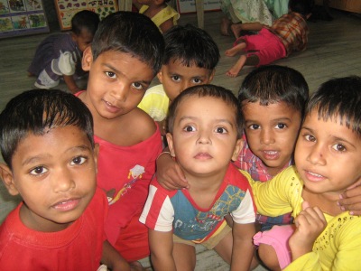 Volunteer playing with children at a care center