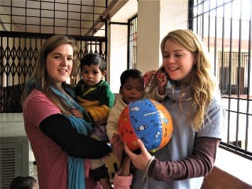 Volunteers painting with children