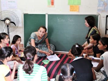 Volunteer and children smiling