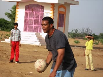 Children learning from volunteer